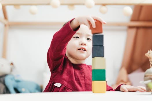 A young child playing with colorful wooden blocks in a cozy playroom setting.