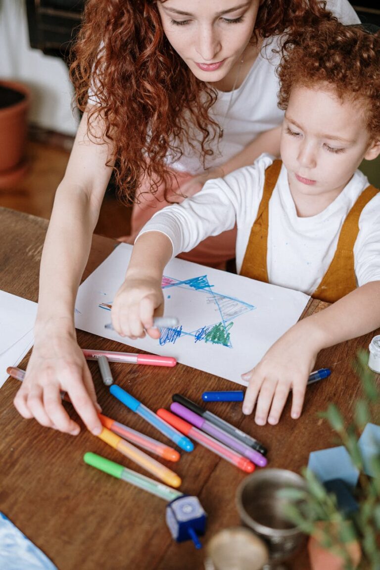 A nurturing moment as a mother and child draw together with colorful markers at home.